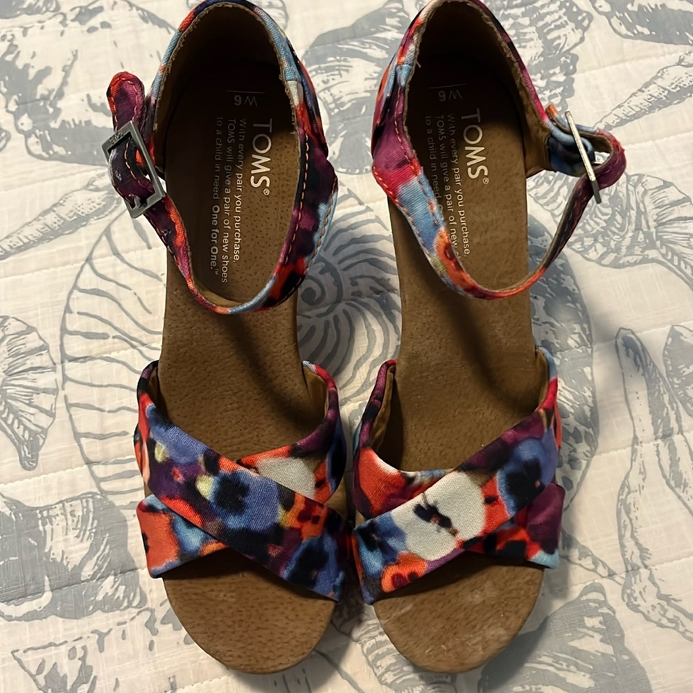 Tom’s sandals. Multi colored floral design. Has 3 1/2 inch heels.